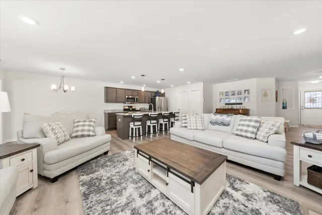 a living room with furniture and kitchen view