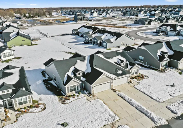 an aerial view of a residential houses with outdoor space