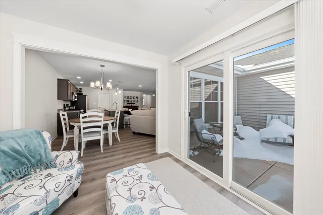 a living room with furniture and a floor to ceiling window