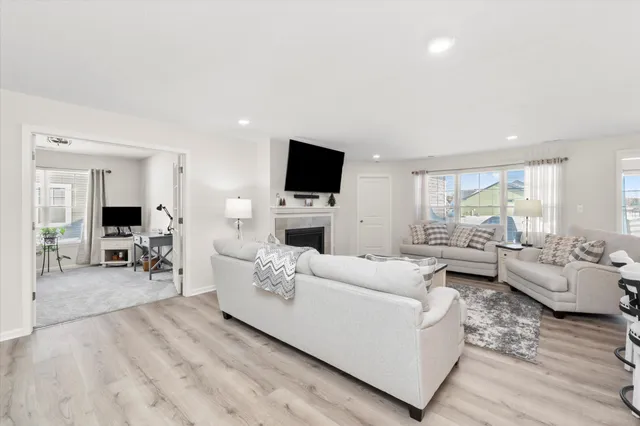 a living room with furniture flat screen tv and a fireplace