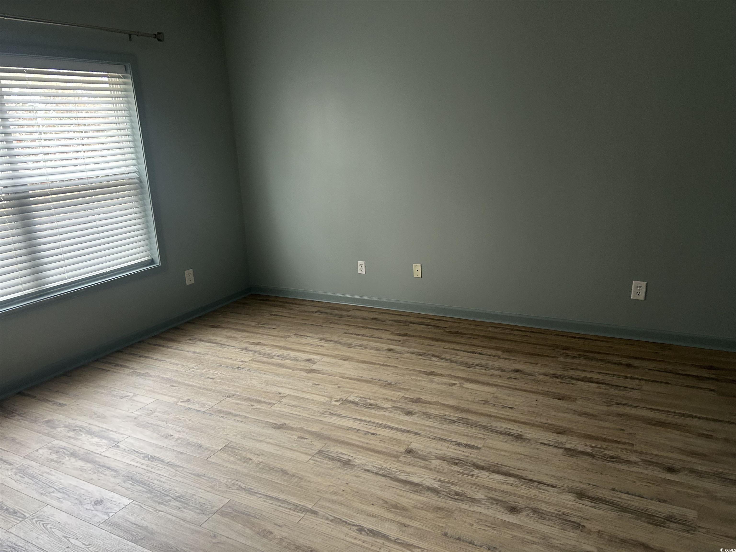 4104 Pinehurst Circle, Unit 2G Little River, SC 29566 - Photo 12 of 17 Spare room featuring light wood finished floors and baseboards