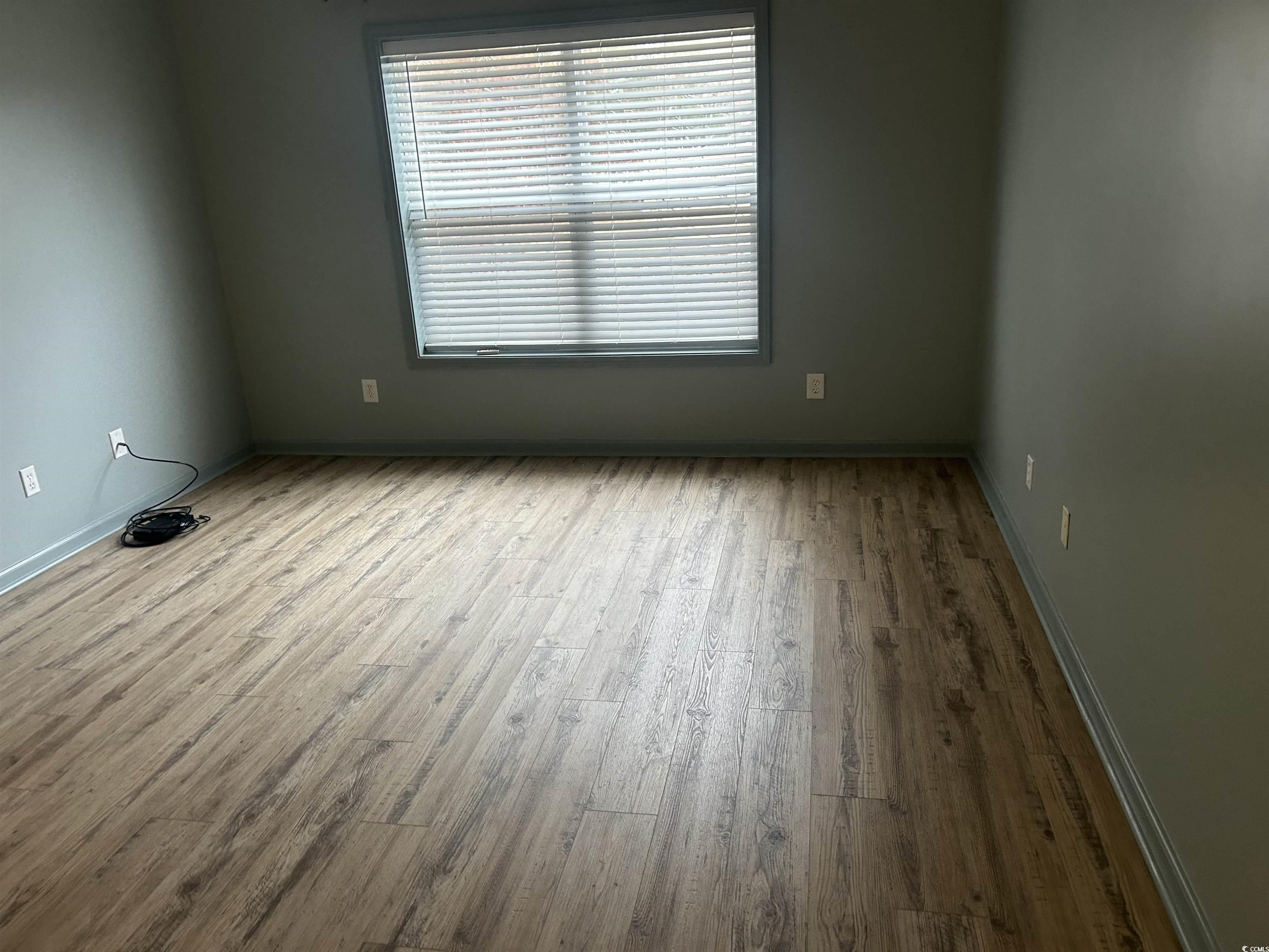 4104 Pinehurst Circle, Unit 2G Little River, SC 29566 - Photo 13 of 17 Unfurnished room with wood finished floors and baseboards