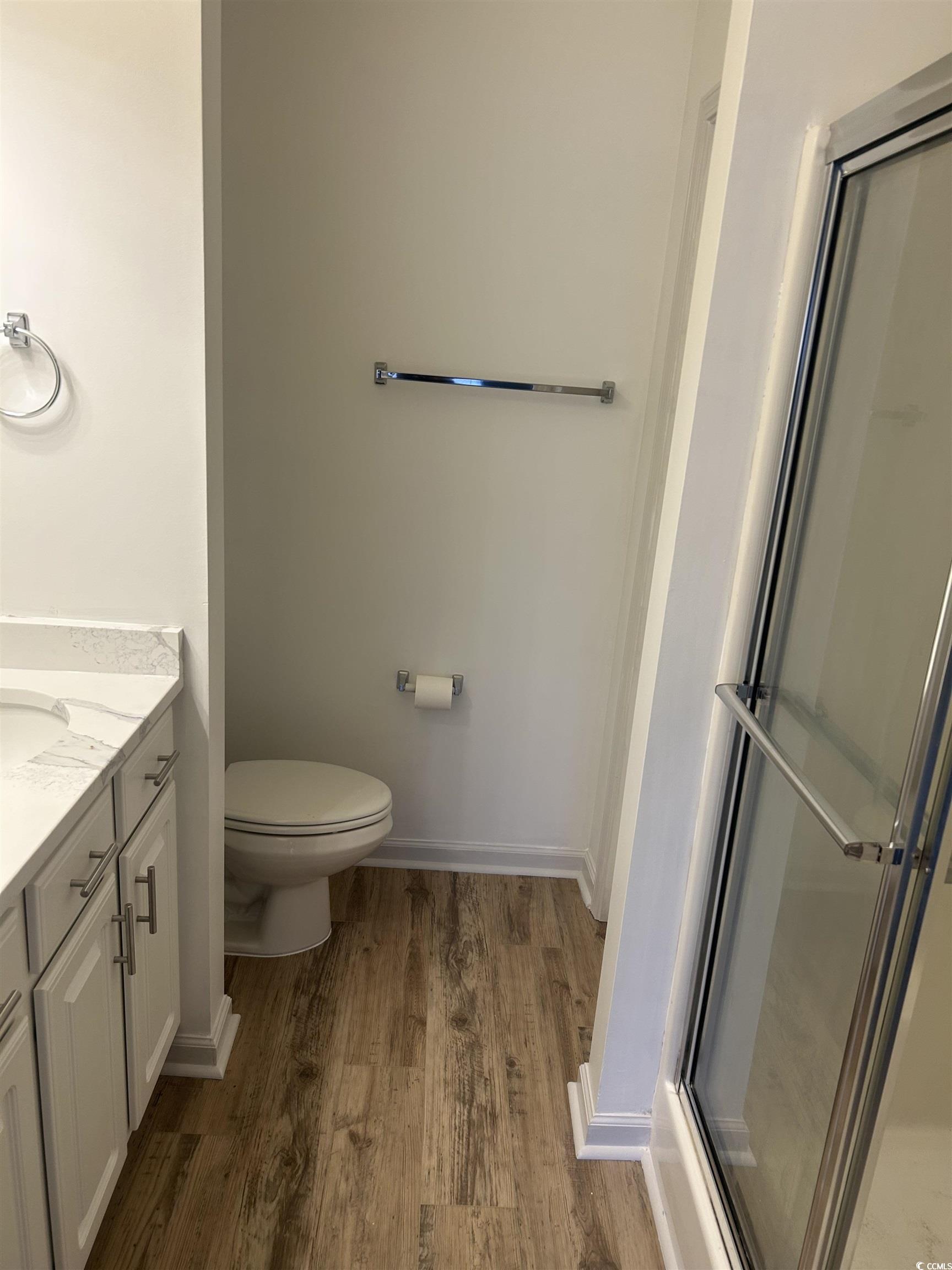 4104 Pinehurst Circle, Unit 2G Little River, SC 29566 - Photo 17 of 17 Full bath featuring a shower stall, vanity, and dark wood-style floors