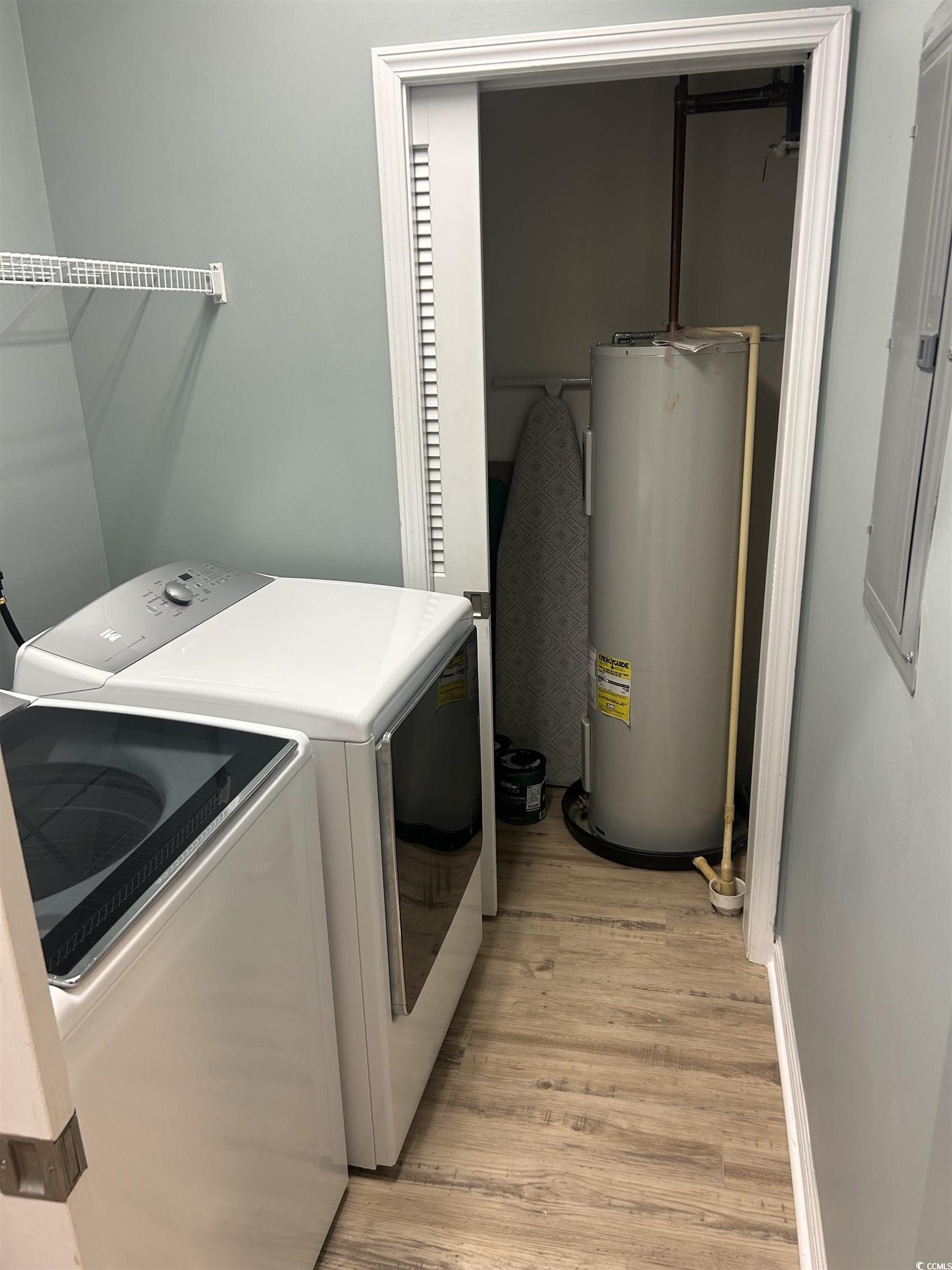 4104 Pinehurst Circle, Unit 2G Little River, SC 29566 - Photo 2 of 17 Laundry area featuring light wood finished floors, electric water heater, washing machine and clothes dryer, and electric panel