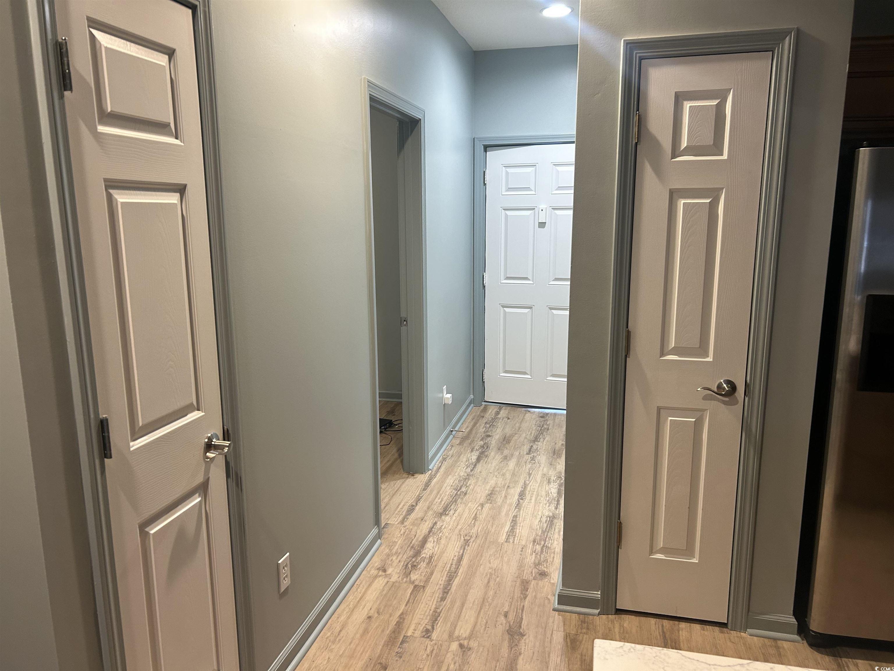 4104 Pinehurst Circle, Unit 2G Little River, SC 29566 - Photo 6 of 17 Hallway with light wood-type flooring and baseboards