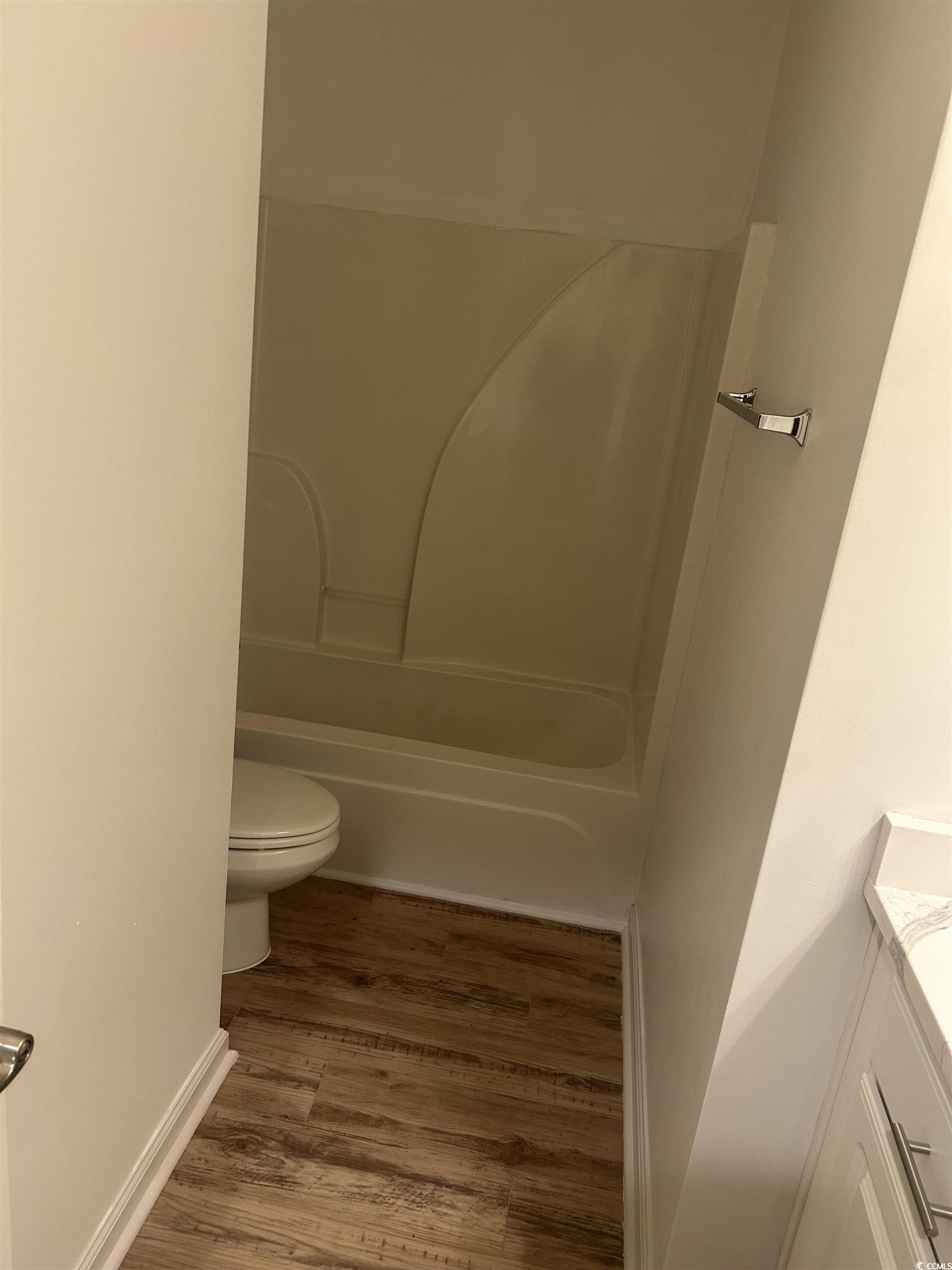 4104 Pinehurst Circle, Unit 2G Little River, SC 29566 - Photo 7 of 17 Full bath with vanity, light wood-style floors, and shower / bathtub combination