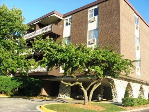 1301 South Finley Road, Unit 112 Lombard, IL 60148 - Photo 2 of 2 a front view of a house with garden