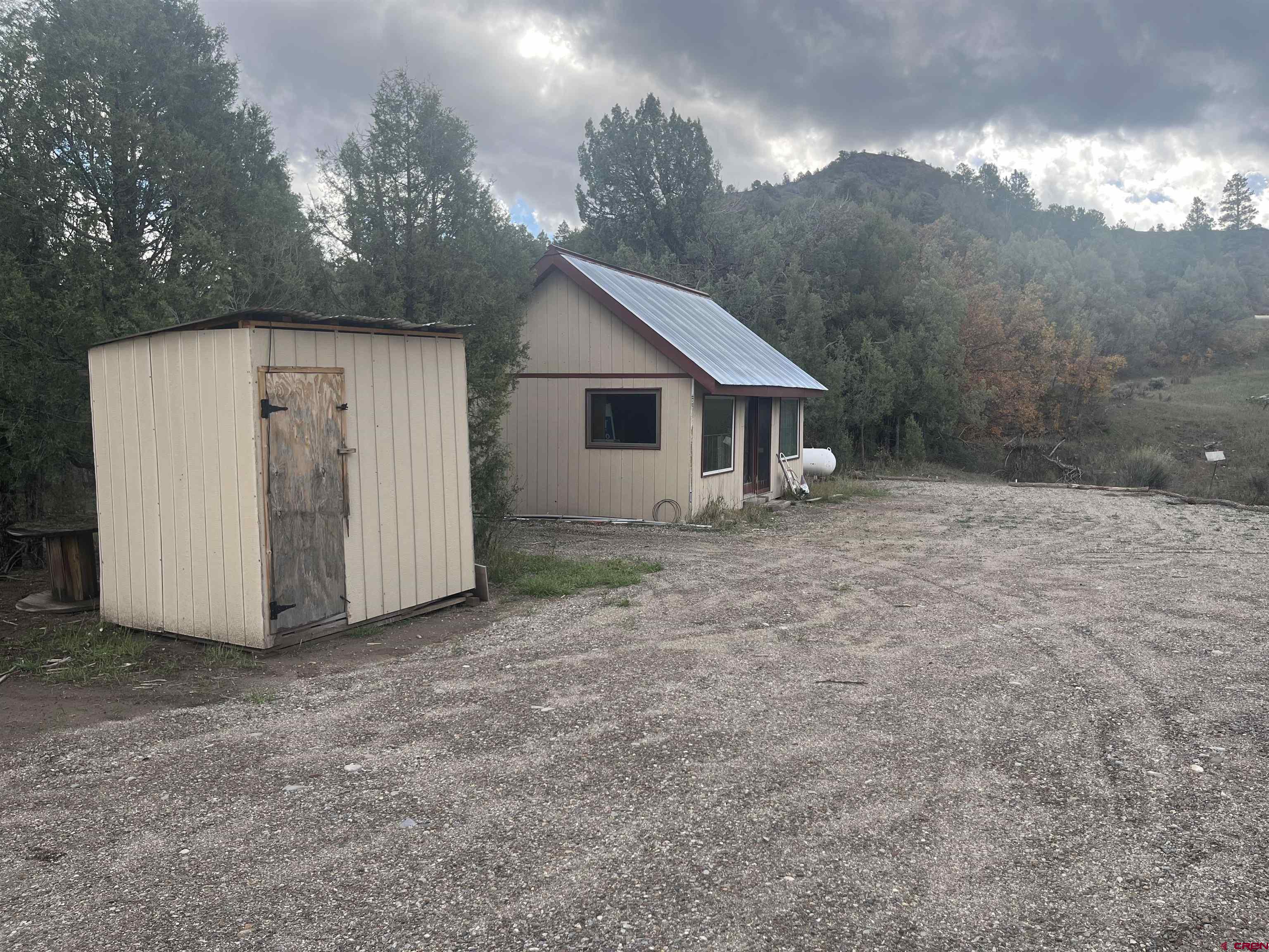 203 Lion Road Durango, CO 81303 - Photo 3 of 22 a view of a house with a yard and garage