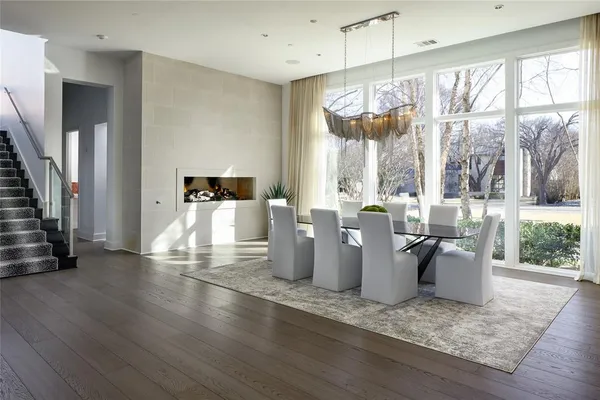 a view of a dining room with furniture water view and wooden floor