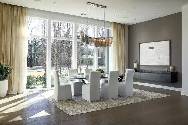 a living room with furniture and large windows