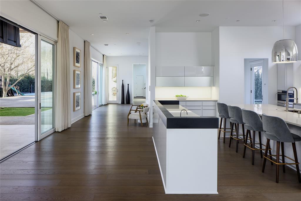 11565 East Ricks Circle Dallas, TX 75230 - Photo 13 of 39 Poggenpohl Kitchen with access to covered loggia and adjacent family room