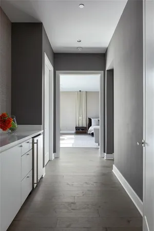 a view of a hallway with bathroom and shower
