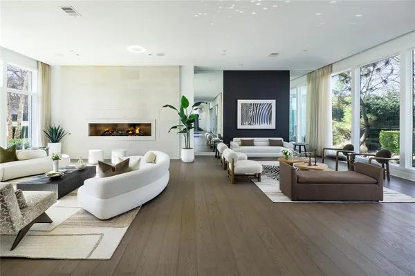 a living room with furniture and large windows