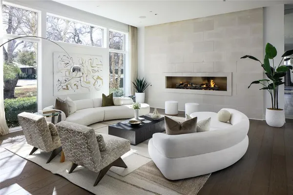a living room with furniture potted plant and a large mirror