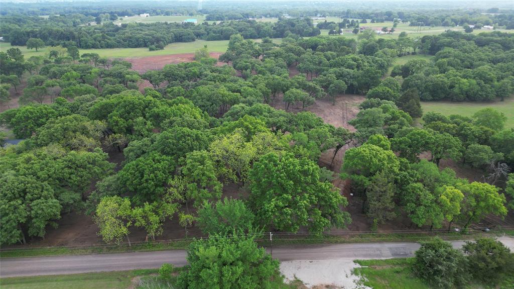 410 W Arkansas Road Sadler, TX 76264 - Photo 3 of 6 an aerial view of green landscape with trees houses and lake view