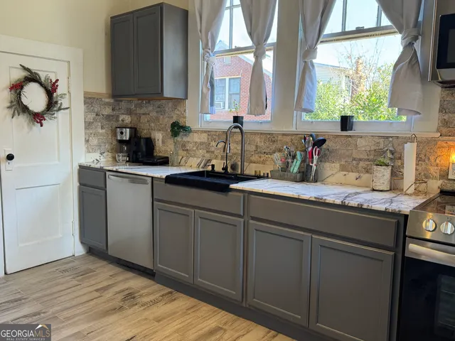 a kitchen with sink cabinets and window