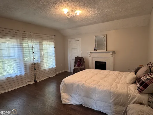 a bedroom with a bed and a couch