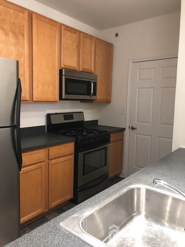 244 Samuel Circle Parlin, NJ 08859 - Photo 3 of 14 a kitchen with a sink and a microwave