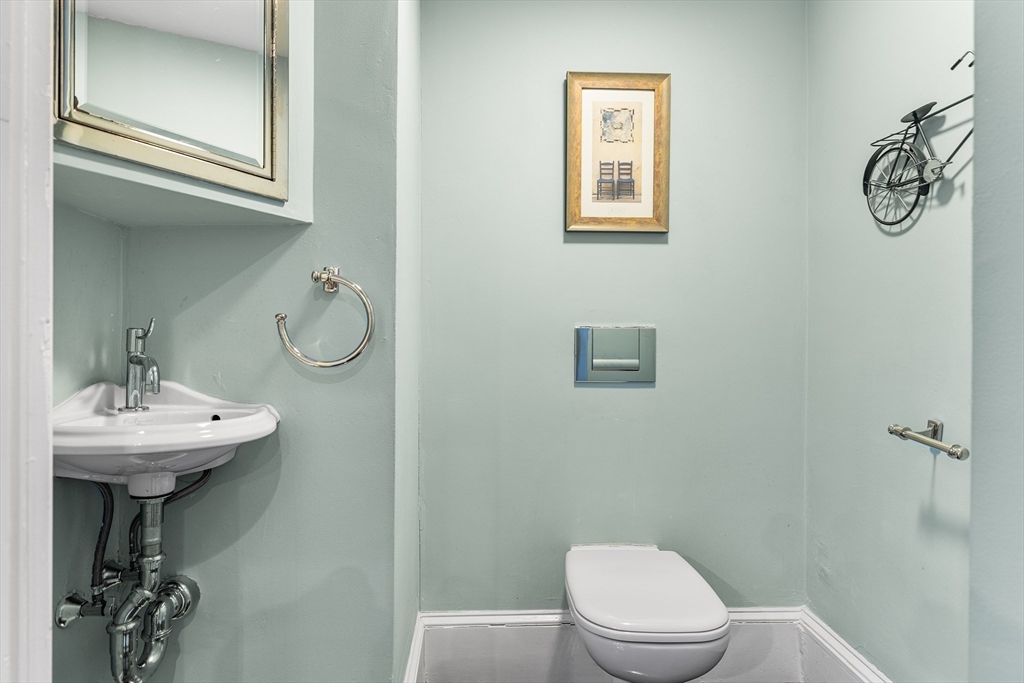405 Cherry Street, Unit 2 Newton, MA 02465 - Photo 17 of 39 a bathroom with a toilet sink and mirror