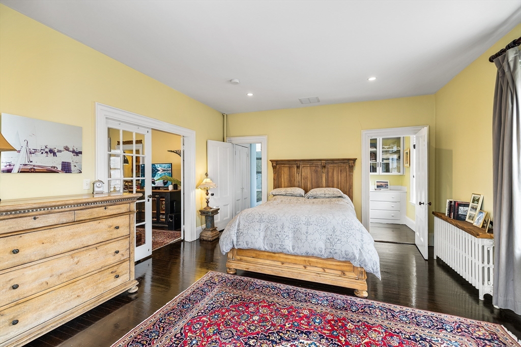 405 Cherry Street, Unit 2 Newton, MA 02465 - Photo 19 of 39 a bedroom with a bed and wooden floor