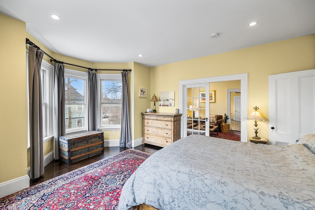 405 Cherry Street, Unit 2 Newton, MA 02465 - Photo 20 of 39 a bedroom with furniture and large window