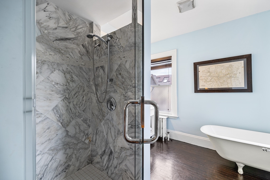 405 Cherry Street, Unit 2 Newton, MA 02465 - Photo 21 of 39 a bathroom with a granite countertop shower a toilet and a sink