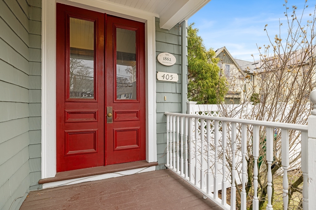 405 Cherry Street, Unit 2 Newton, MA 02465 - Photo 4 of 39 a view of a wooden house with a red door and a large window