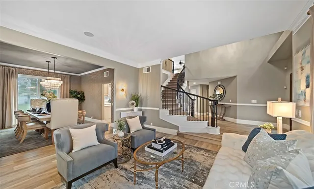 a large white kitchen with a stove a sink dishwasher and a refrigerator with wooden floor