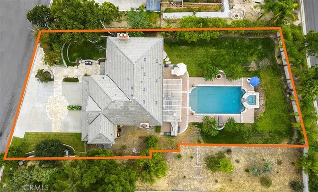 an aerial view of house with yard swimming pool and outdoor seating