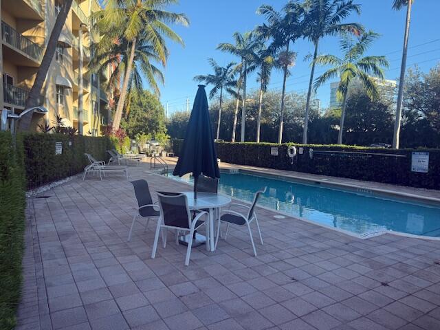1650 Presidential Way, Unit 506 West Palm Beach, FL 33401 - Photo 14 of 15 a view of a chairs and table in backyard of a house