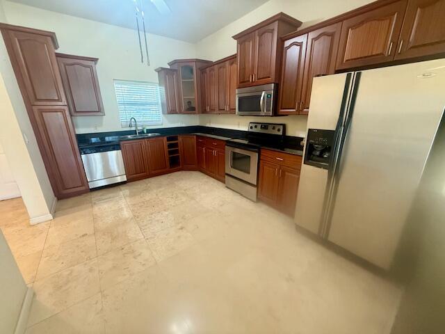 1650 Presidential Way, Unit 506 West Palm Beach, FL 33401 - Photo 3 of 15 a kitchen with stainless steel appliances granite countertop a refrigerator a stove top oven a sink and dishwasher