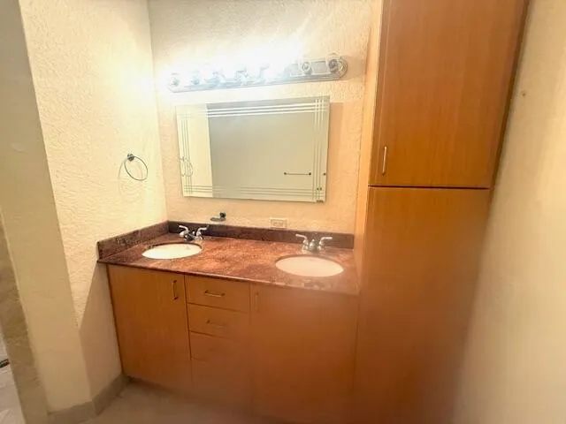 a bathroom with a tub sink and mirror