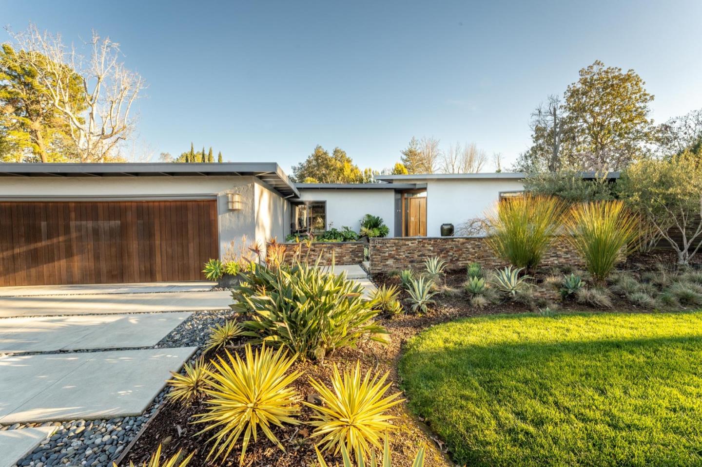 a view of a house with pool and sitting area