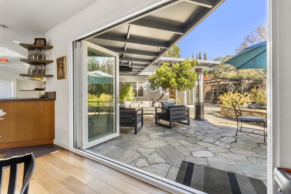 Undisclosed Address Stanford, CA 94305 - Photo 19 of 45 a view of a patio with table and chairs and potted plants