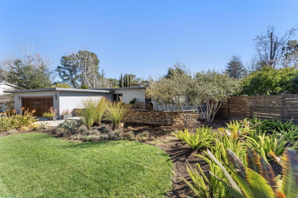 Undisclosed Address Stanford, CA 94305 - Photo 6 of 45 a view of a backyard with plants and a garden