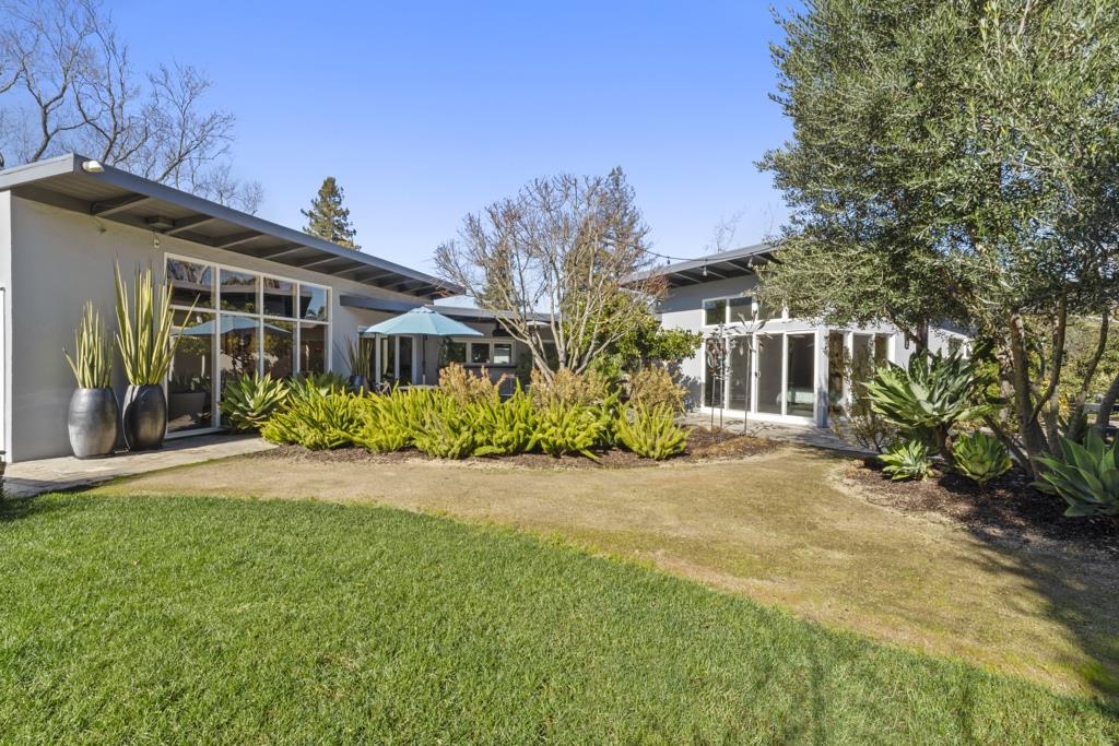 Undisclosed Address Stanford, CA 94305 - Photo 10 of 45 a front view of a house with a yard and potted plants