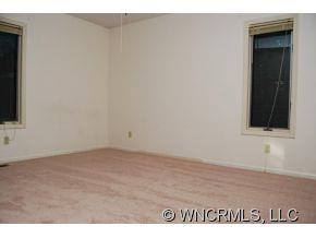 4 Edna Oaks Road Hendersonville, NC 28792 - Photo 12 of 19 a view of an empty room and window