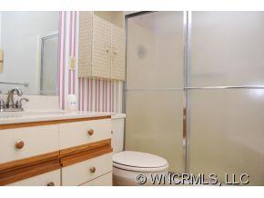 4 Edna Oaks Road Hendersonville, NC 28792 - Photo 14 of 19 a bathroom with a sink a toilet and shower
