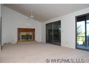 4 Edna Oaks Road Hendersonville, NC 28792 - Photo 6 of 19 a view of an empty room with window and fire place