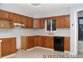 4 Edna Oaks Road Hendersonville, NC 28792 - Photo 7 of 19 a kitchen with stainless steel appliances granite countertop a stove a sink and a microwave
