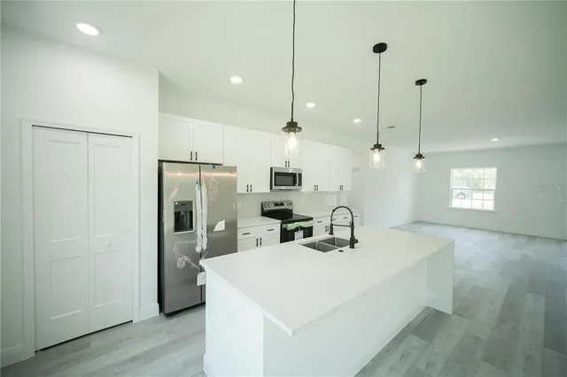 a kitchen with stainless steel appliances granite countertop a refrigerator and a stove