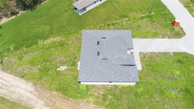 an aerial view of a house with a yard