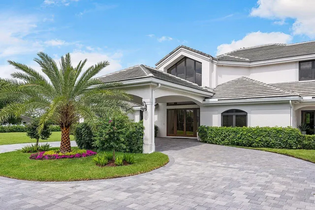 a living room with furniture a flat screen tv and a floor to ceiling window