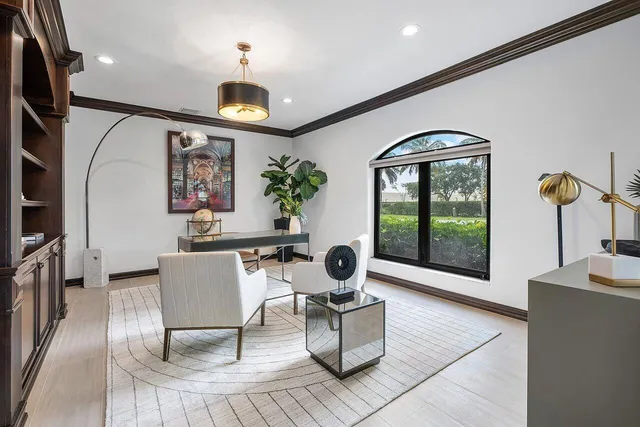 a kitchen with stainless steel appliances granite countertop table chairs and a refrigerator