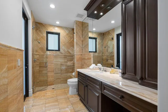an aerial view of residential house with outdoor space and trees all around