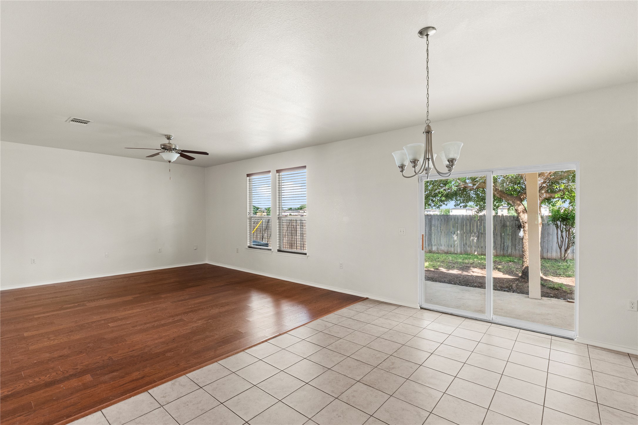 8613 Capitol View Drive Austin, TX 78747 - Photo 24 of 33 Natural light floods this living area, offering wood and tile floors with convenient outdoor access.