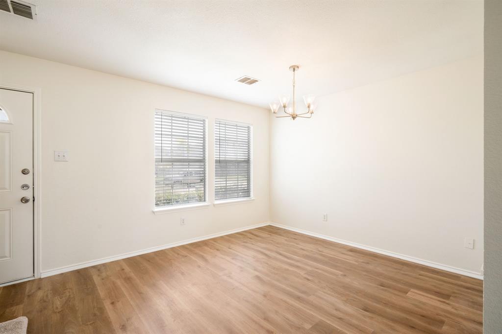 1626 White Oak Road Anna, TX 75409 - Photo 14 of 30 an empty room with wooden floor and windows