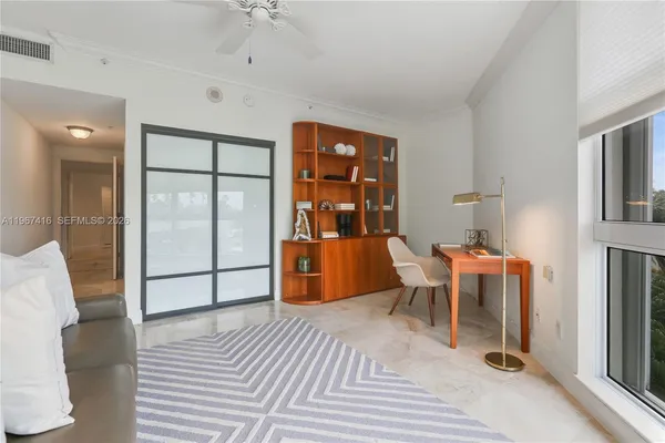 a bedroom with furniture and a window