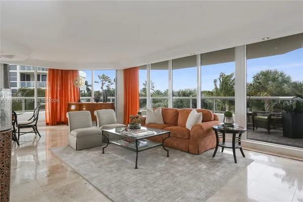 a living room with furniture and a floor to ceiling window