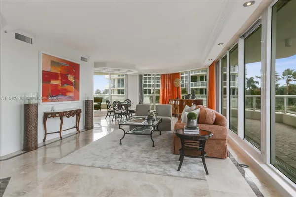 a living room with furniture and a floor to ceiling window
